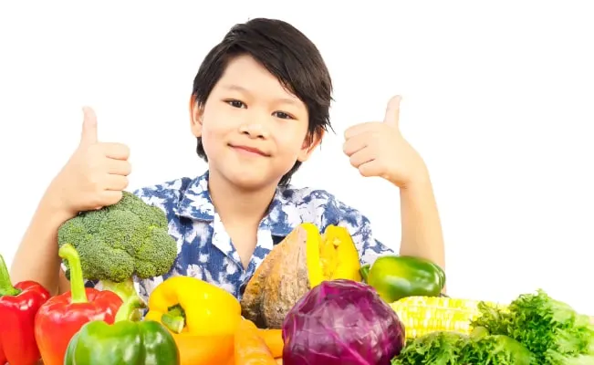 Young student with glasses focused on writing.